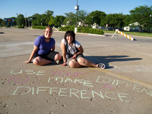 Two delegates chalk draw "Use Your Difference to Make a Difference"